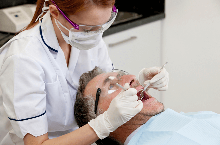 Man at dentists getting a root canal treatment in Derby
