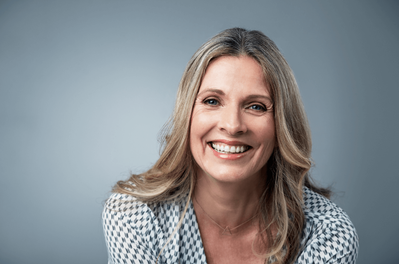 old woman with dental implants smiling