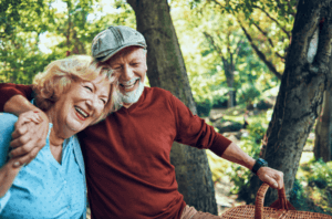 Man and woman with dental implants in Derby smiling