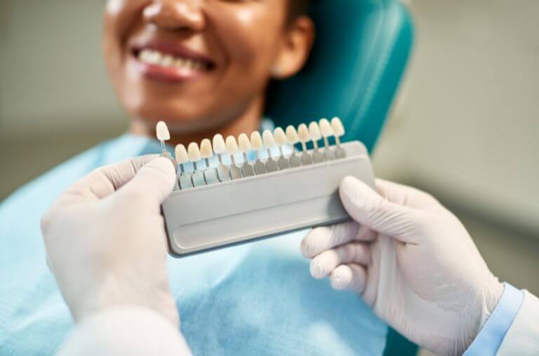 showing teeth whitening colour options to patient