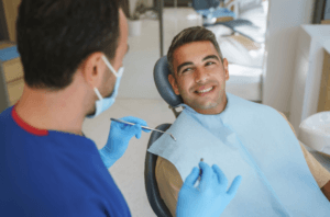 Man sat in the dentist chair before having his gums examined